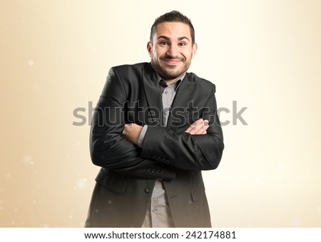 businessman with arms crossed over ocher background 