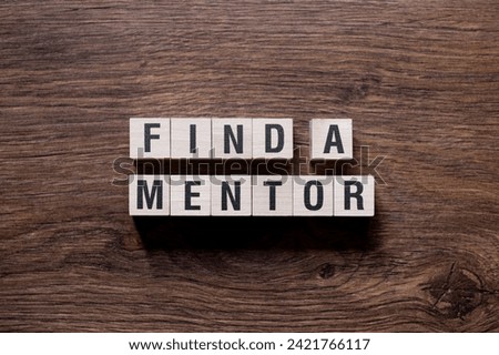 Find a mentor - word concept on building blocks, text