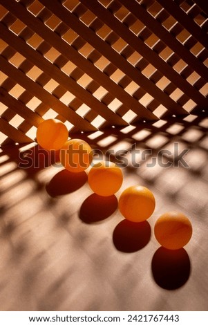 Abstract background with wooden grid and orange balls