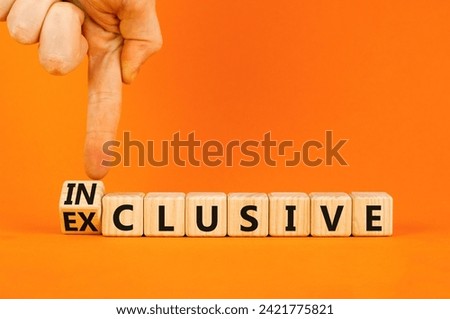 Inclusive or exclusive symbol. Concept word Exclusive and Inclusive on wooden cubes. Businessman hand. Beautiful orange table orange background, copy space. Business inclusive or exclusive concept.