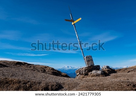 View of Dufourspitze mountain from Mount Generoso with a boarder milestone close-up (the arrows indicates the trails name) Royalty-Free Stock Photo #2421779305