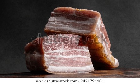 Two large pieces of bacon. The background picture.