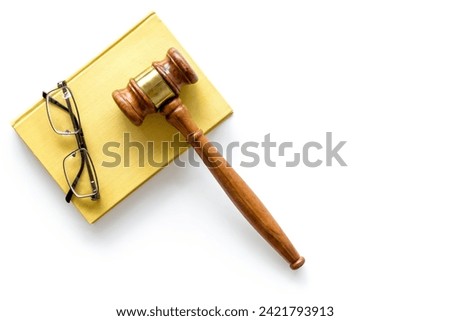 Wooden judge gavel with law book, top view. Law education concept.