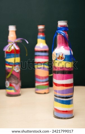 transparent bottle with colorful sand, decorative bottle, glass interior decor Royalty-Free Stock Photo #2421799017