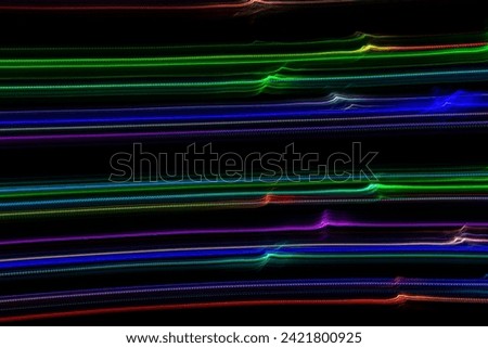 Abstract Colorful wave lines on a black background. Long exposure photography
