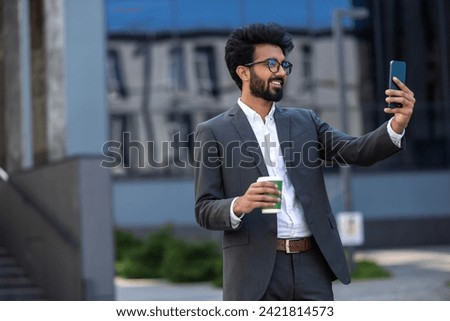 Elegant hindu young man with a phone in hands