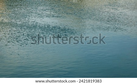 Background of the water surface of the Salzach river. Texture of water of a mountain river.