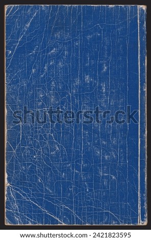Old, grunge background texture. Beautiful blue color of an old book. Excellent detail and exquisite textured pattern of antique material with abundant cracks.