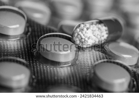 medical pills on black and white background Royalty-Free Stock Photo #2421834463