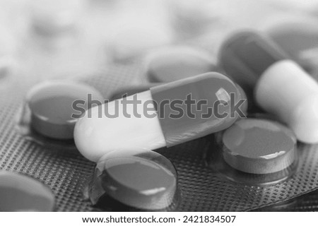medical pills on black and white background Royalty-Free Stock Photo #2421834507