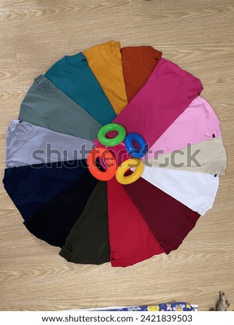 Colorfull t shirt with cotton basic material with background Royalty-Free Stock Photo #2421839503