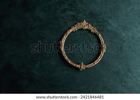 Vintage openwork round bronze metal frame on the old wall background, empty picture frame mockup Royalty-Free Stock Photo #2421846481
