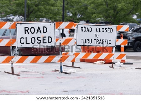 Public construction signs closing off a road.