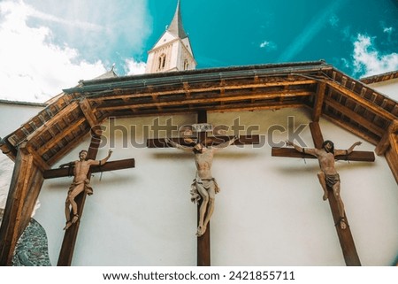 Jesus Christ and two martyrs crucifixion on wooden crosses in the Church of St. Leonard.Church of St. Leonard in Lungau, Austria. August 2023.