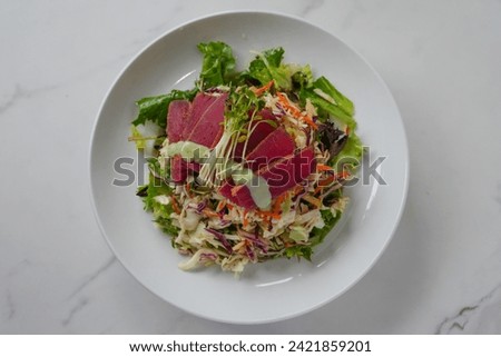 seared ahi tuna salad on a white background Royalty-Free Stock Photo #2421859201