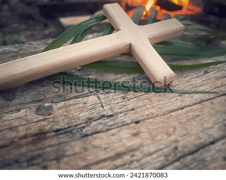 Lent, Holy Week, Palm Sunday concept - wooden cross in retro background with copy space. Stock photo.