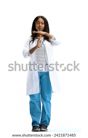 A full-length female doctor, on a white background, shows a pause sign