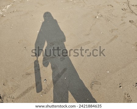 human shadows on the beach sand in various types of poses