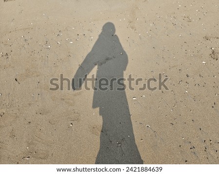 human shadows on the beach sand in various types of poses