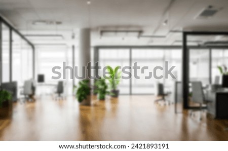 Light blur Minimalist Open Space Office background. Blurred Modern contemporary office and meeting room, interior design. with panoramic glass windows and green plant inside and Wooden floor