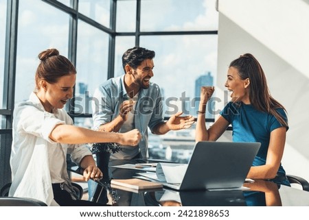 Group of happy businesspeople celebrate their successful project. Professional business team win and proud of their project at modern office. Successful teamwork, happy colleague, workplace. Tracery.