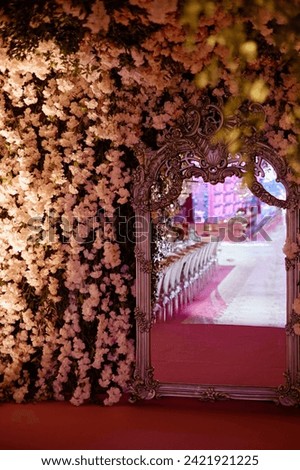 Upon entering the wedding ceremony area through the corridor, guests are greeted by an antique-style mirror and a full-length mirror. stock photo