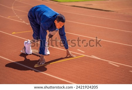 Asian para-athlete runner prosthetic leg on the track alone outside on a stadium track Paralympic running concept.