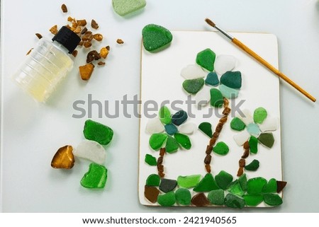 Sea glass is small polished pieces of broken bottles and other glass products collected on the beach and pieces of amber. A gift for a holiday on March 8, birthday, mother's day. Royalty-Free Stock Photo #2421940565