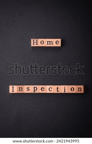 The inscription Home inspection made of wooden cubes on a plain background. Can be used for your design