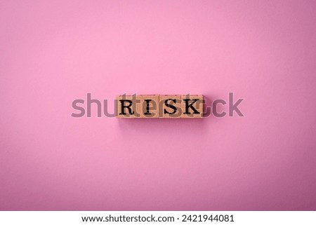 The inscription Risk made of wooden cubes on a plain background. Can be used for your design
