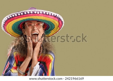 Mature woman in sombrero hat on color background. Mexico's Day of the Dead (El Dia de Muertos) celebration Royalty-Free Stock Photo #2421966169