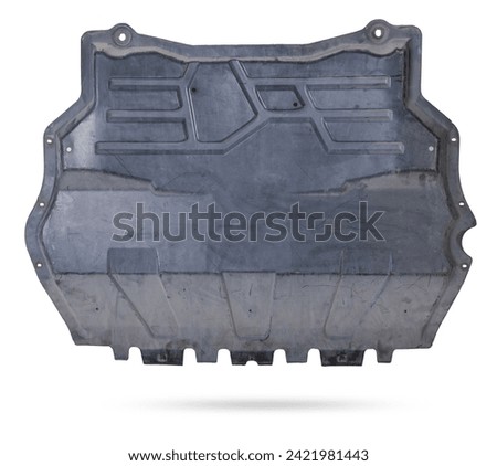 Black plastic engine cover liner on a white isolated background for sale or replacement in a car service. Mudguard on auto-parsing for repair or a device to protect the body from dirt. Royalty-Free Stock Photo #2421981443