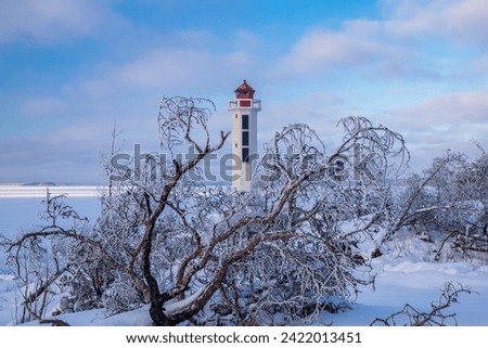 Winter Finnish lighthouse Kuninkaansaari (Povorotny), Vikhrevoy Island, Vyborg Bay, Gulf of Finland, Russia Royalty-Free Stock Photo #2422013451