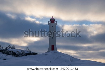 Winter Finnish lighthouse Kuninkaansaari (Povorotny), Vikhrevoy Island, Vyborg Bay, Gulf of Finland, Russia Royalty-Free Stock Photo #2422013453