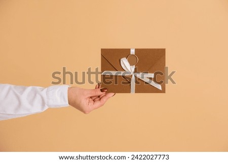 discount card or gift certificate in envelope on beige background