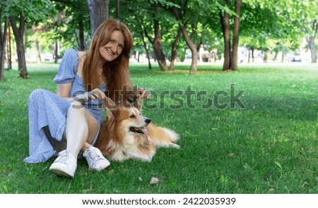 beautiful corgi dog and girl in the park
