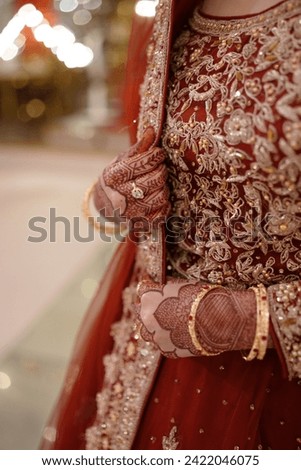A picture of Asian bride who looks beautiful in traditional red lehnga and gives us traditional wedding vibes 