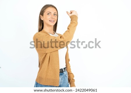 Profile photo of Young beautiful businesswoman supporting soccer team raise fist shouting