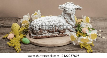 Easter lamb cake with traditional spring decor. Baked sweet dessert with sugar icing. Festive background, classic holiday symbols. Wooden background, banner format