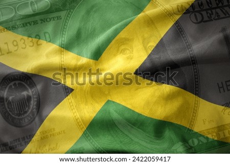 waving colorful national flag of jamaica on a american dollar money background. finance concept.