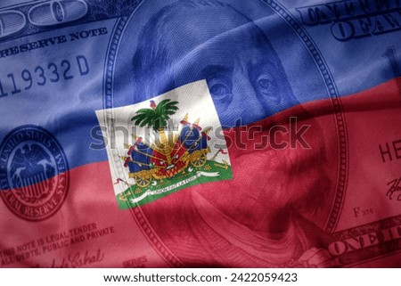 waving colorful national flag of haiti on a american dollar money background. finance concept.