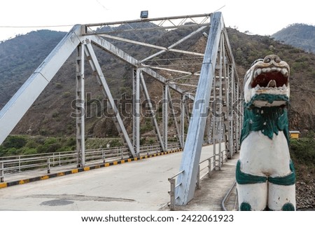 Richly decorated Bhutanese lion at the bridge over the Drangme Chhu river in Trashigang, Bhutan, Asia Royalty-Free Stock Photo #2422061923