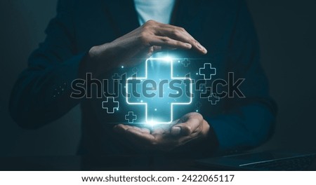 Businessman holding virtual blue plus sign for positive thinking mindset or healthcare insurance symbol concept for mental rejuvenation. Business value added. increase investment growth, benefits add, Royalty-Free Stock Photo #2422065117