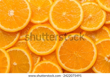 oranges cut into slices and laid out on the table as a food background 5 Royalty-Free Stock Photo #2422075491