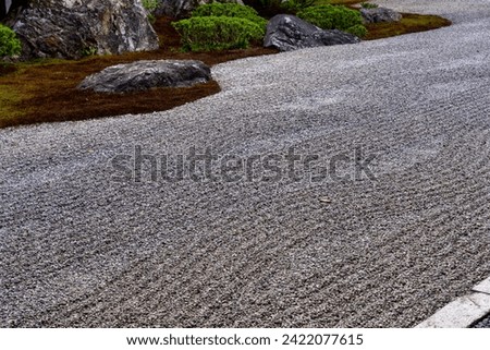 a wave of pebbles in front of the yard