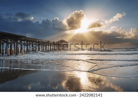 Longing view of Cocoa beach pier in Florida. Sunrise on the ocean. Royalty-Free Stock Photo #2422082141