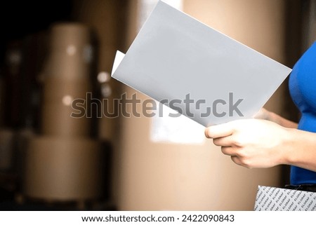 Girl reading blank black flyer brochure booklet. Leaflet presentation. Pamphlet hold hands. Woman show clear offset paper. Sheet template Booklet design sheet display read first person.