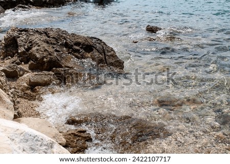 Blue Mediterranean Sea. Clear Water. Stones at the Bottom of the Mediterranean Sea.  Small Waves.
