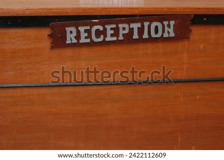 the reception sign on the desk is worn out