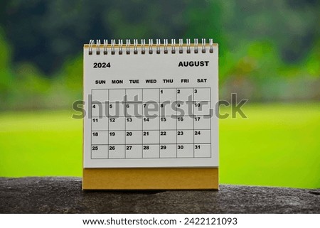 August 2024 white calendar with green blurred background - New year concept.